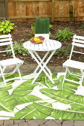 Veranda VR-62 green hand-hooked polypropylene rug styled on outdoor patio